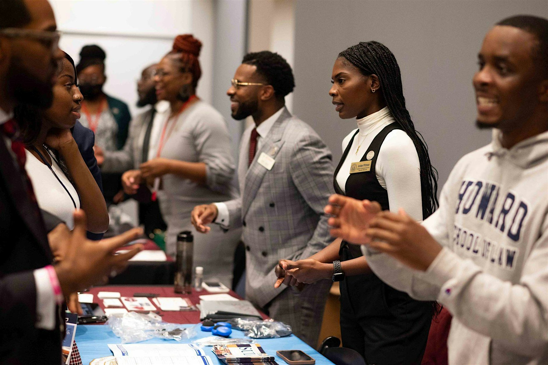 Law school representatives speaking with HBCU students across exhibitor tables on the Law Expo floor